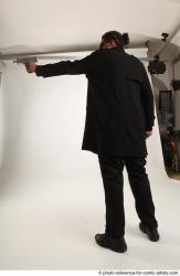 Man Adult Average Black Fighting with gun Standing poses Coat